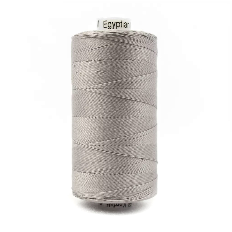 A spool of Konfetti KT905 - Sterling Grey thread on a white background