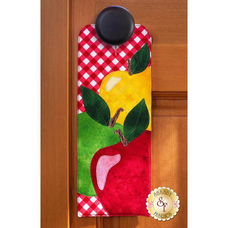 Door hanger kit for A-door-naments September with red, green, and yellow apples on red gingham.