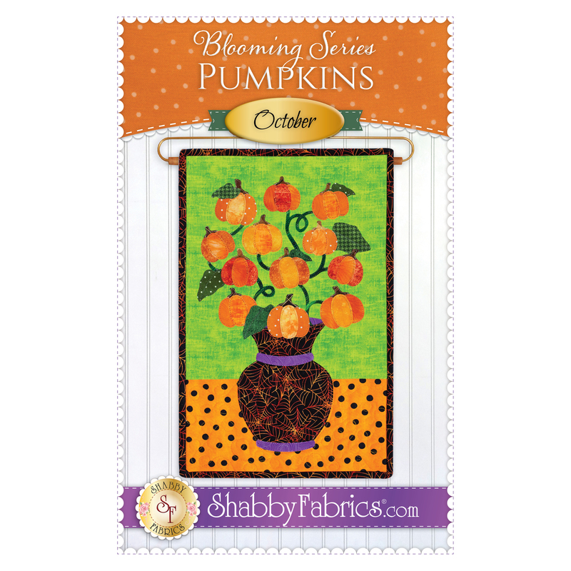 The front of the Blooming Series - October pattern by Shabby Fabrics showing the finished project with a bouquet of pumpkins for Halloween.