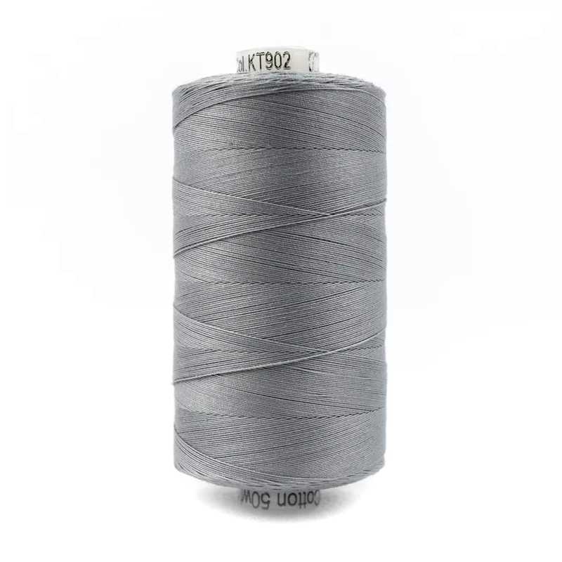 A spool of Konfetti KT902 - Medium Grey thread on a white background
