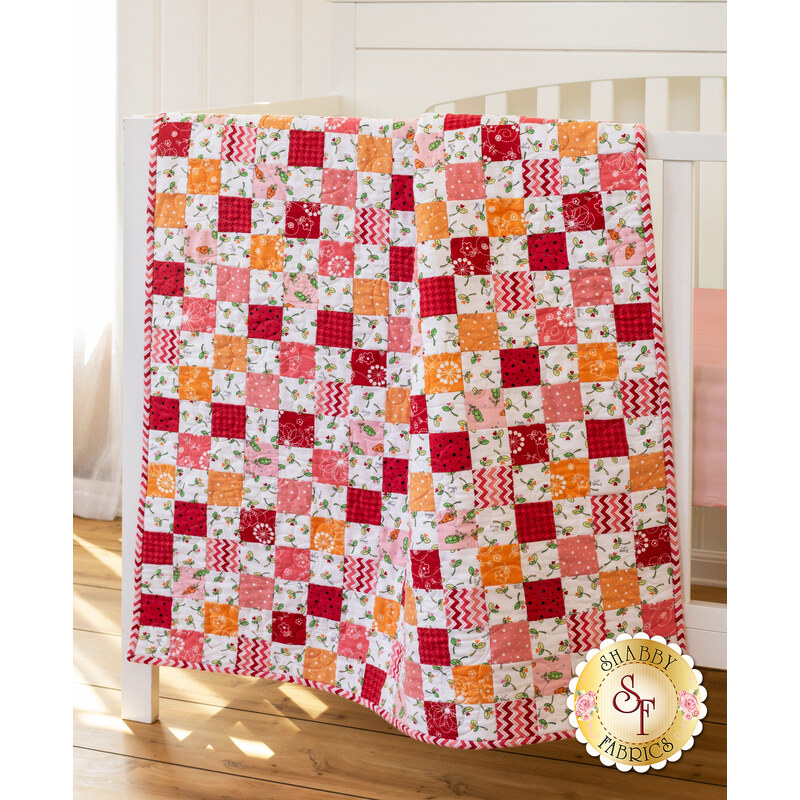 Pink, red, and orange flannel patchwork quilt with fun variegated prints.