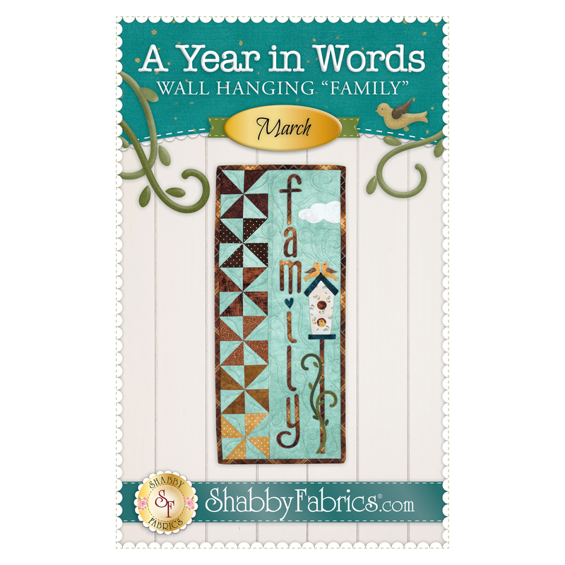 The front of the A Year In Words Wall Hanging Pattern - March by Shabby Fabrics showing the finished wall hanging with the word Family, a tall birdhouse, and ombre pinwheels down the side.