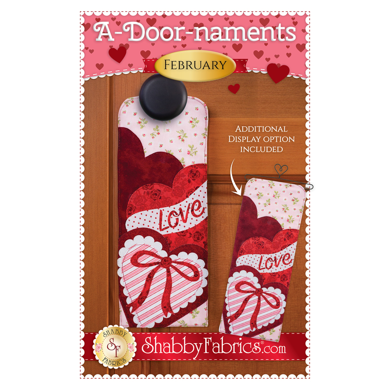 The front cover of the A-Door-naments - February pattern by Shabby Fabrics showing the finished door hanger with three valentine hearts.