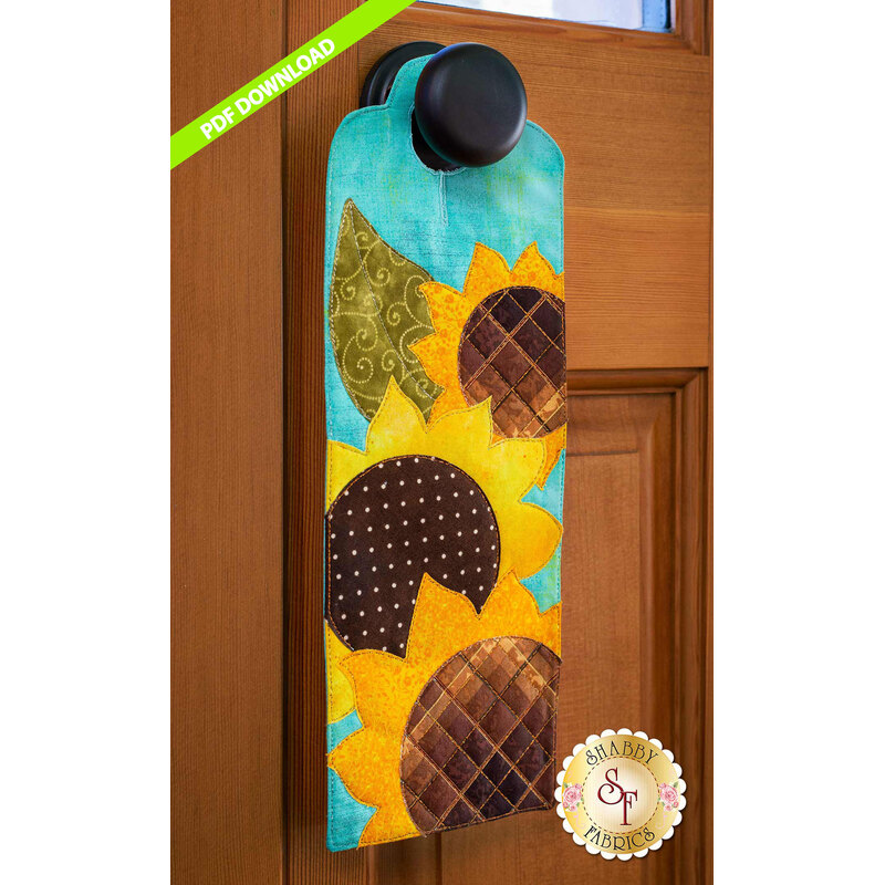 PDF Pattern for A-door-naments August with three yellow sunflowers on teal fabric.