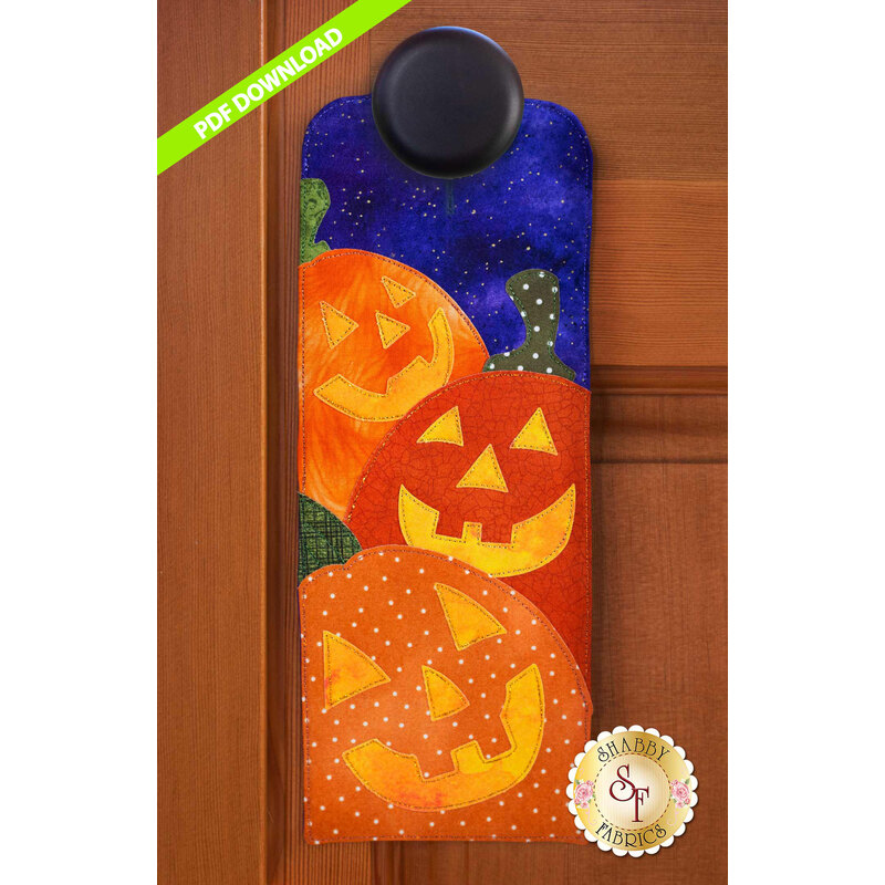 PDF Pattern for A-door-naments October with three smiling jack-o-lanterns on violet fabric.