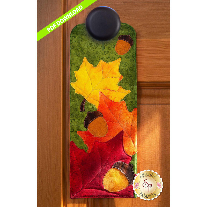 PDF Pattern for A-door-naments November with autumn leaves and acorns on green fabric.