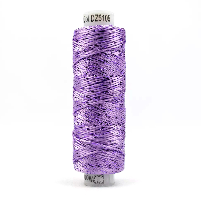 A spool of WonderFil Dazzle 5105 - Orchid Bloom thread on a white background