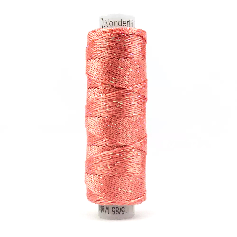 A spool of WonderFil Dazzle - 1127 Apricot Blush thread on a white background