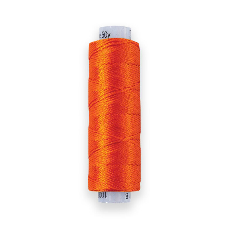 A spool of WonderFil Razzle RZ27 Orange thread on a white background