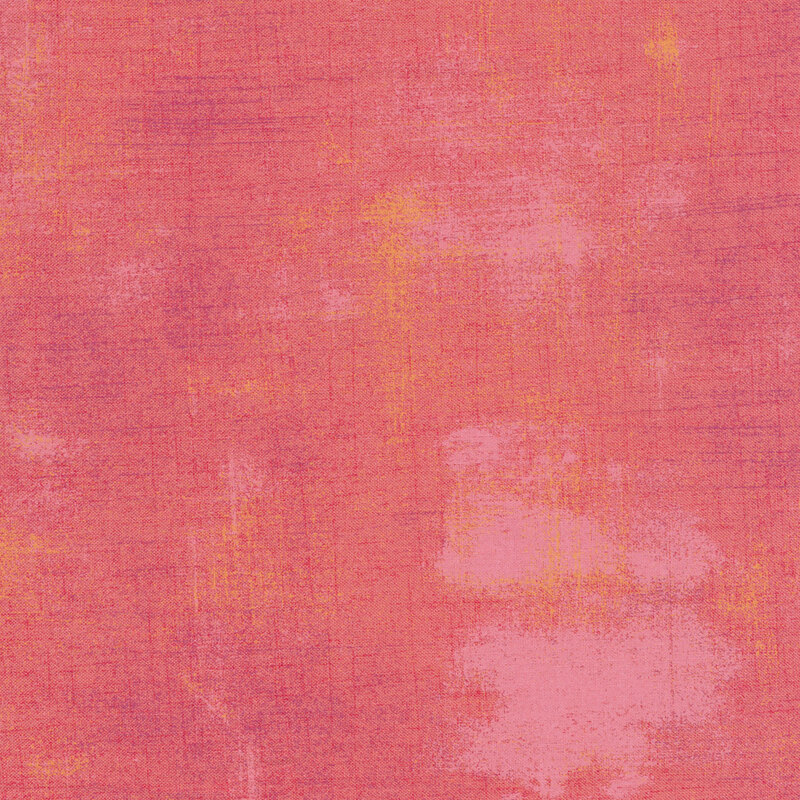 A salmon colored grunge textured fabric
