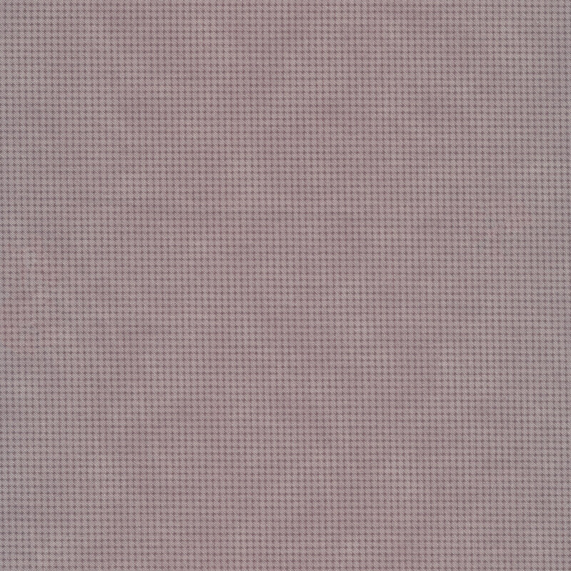 Tonal light purple mottled fabric with houndstooth patterns all over