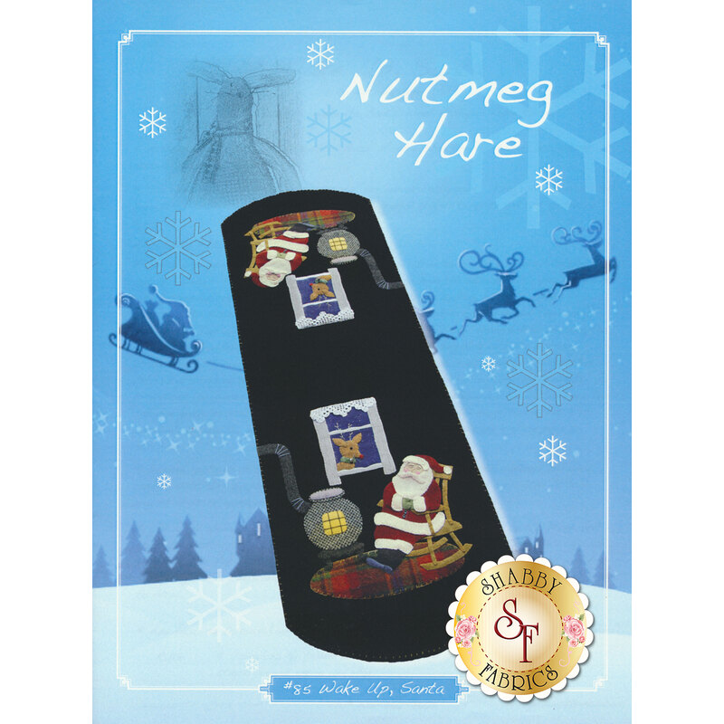The cover of Wake Up, Santa Pattern featuring Santa Claus by a wood stove | Shabby Fabrics
