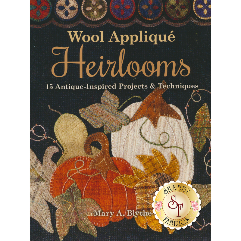 The front of the Wool Applique Heirlooms Book showing some vintage wool projects
