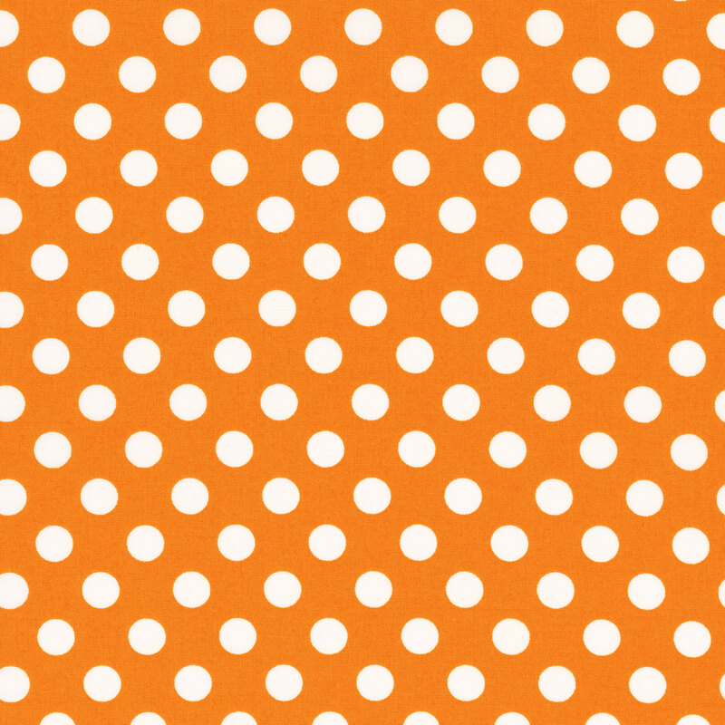 fabric featuring an orange background with white polka dots