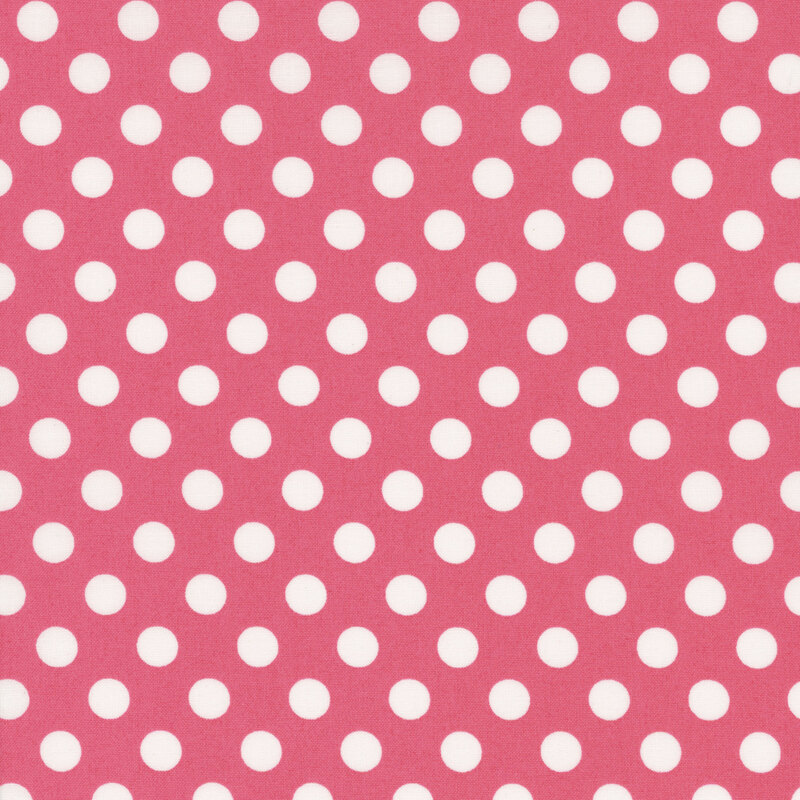 fabric featuring a pink background with white polka dots