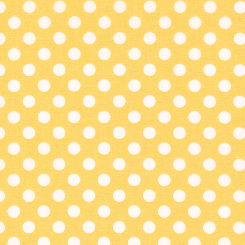 fabric featuring a yellow background with white polka dots