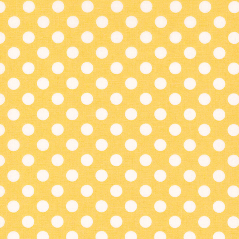 fabric featuring a yellow background with white polka dots