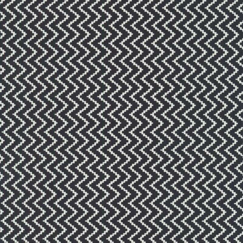 Fabric features cream pixelated zig zag on black background | Shabby Fabrics