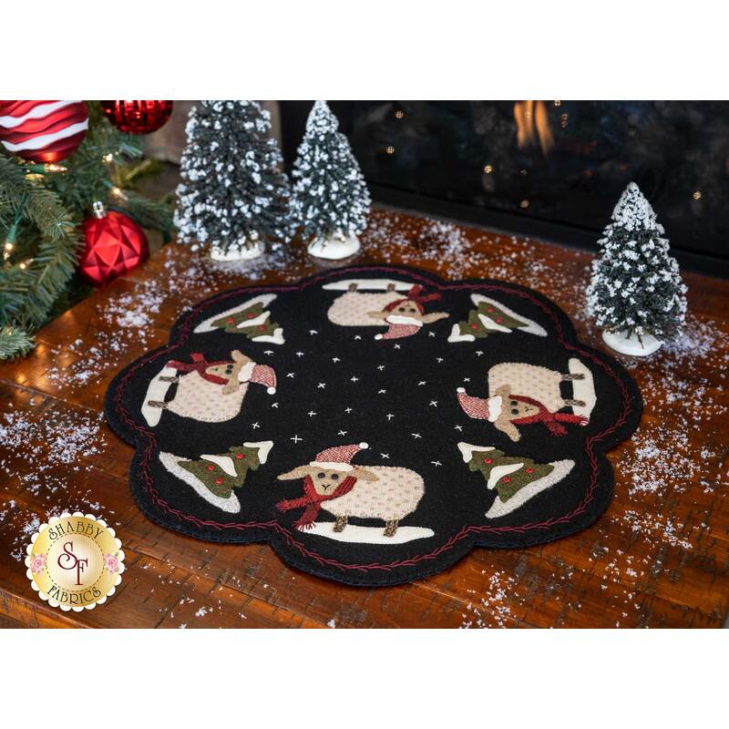 Black wool mat featuring adorable sheep and Christmas trees | Shabby Fabrics