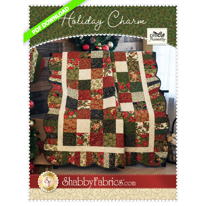 A red, pale green, and pale blue patchwork quilt made from squares with a scalloped border.