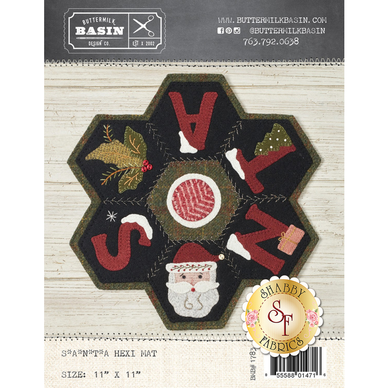 The front of the SANTA Wool Hexi Mat pattern showing the finished mat which shows 6 hex's containing an S, Santa's face in place of an A, a N with a Christmas gift, a T with a tree, an A, and holly & berries.