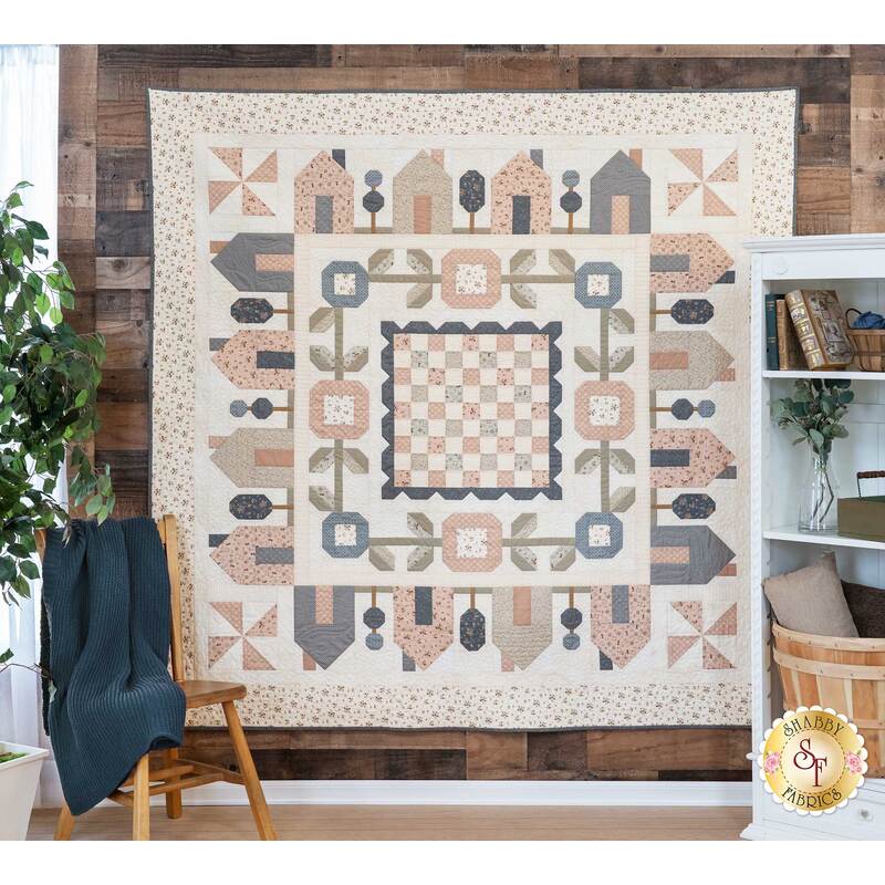 The beautiful Springville quilt hanging on a wall | Shabby Fabrics