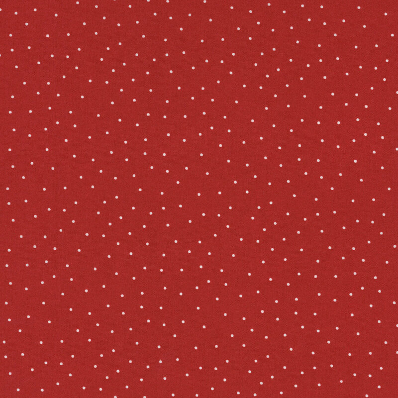 fabric featuring a brick red background with scattered small white dots