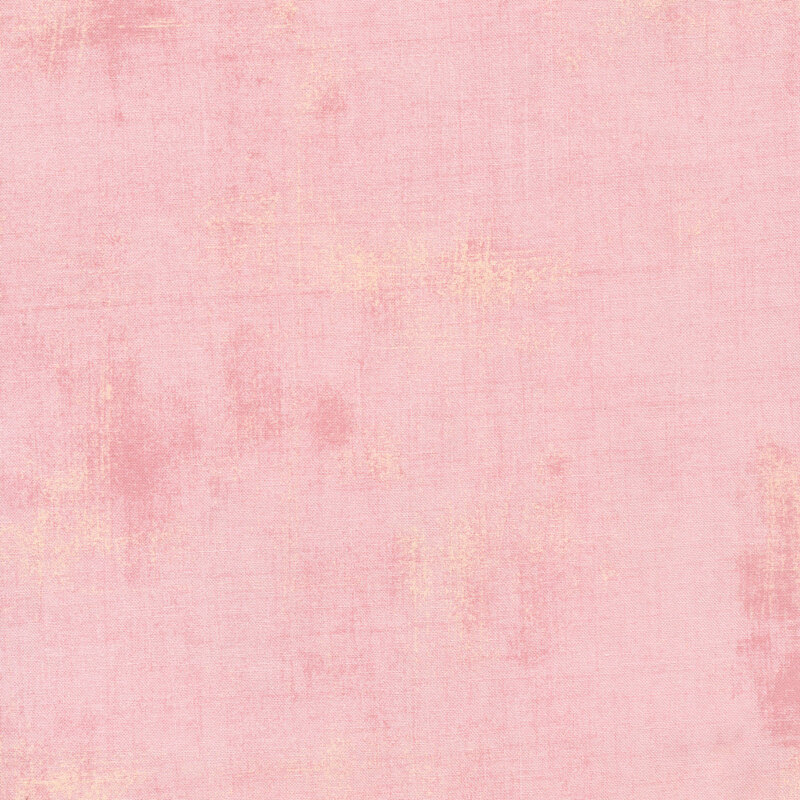 A pastel pink colored grunge textured fabric