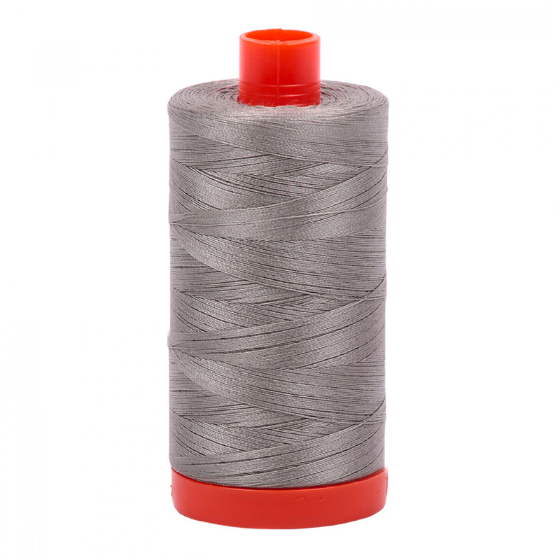 A spool of the Aurifil 6732 - Earl Gray thread on a white background