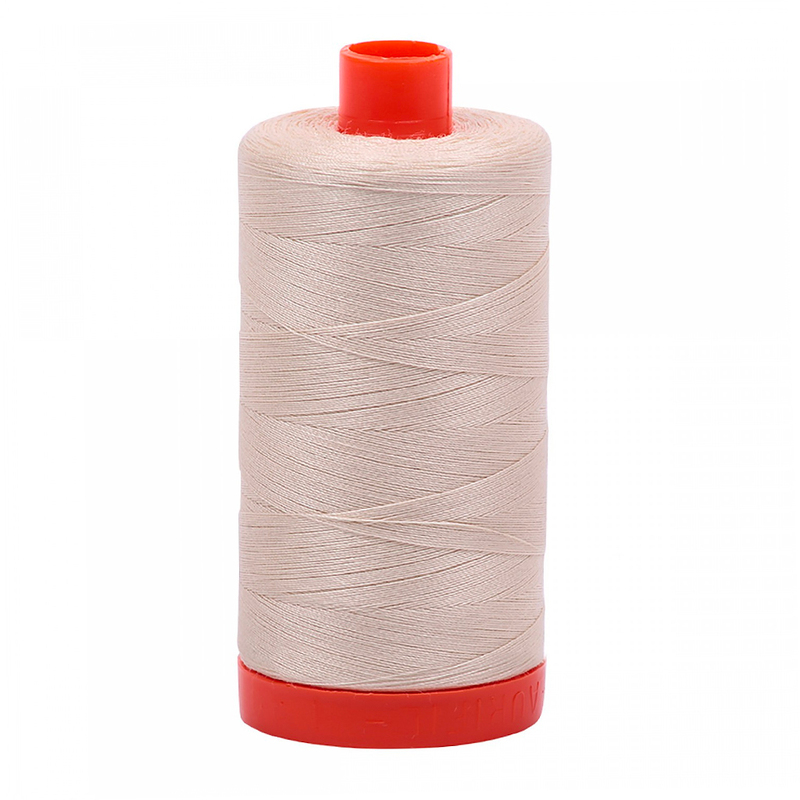 A spool of Aurifil 2310 - Light Beige thread on a white background