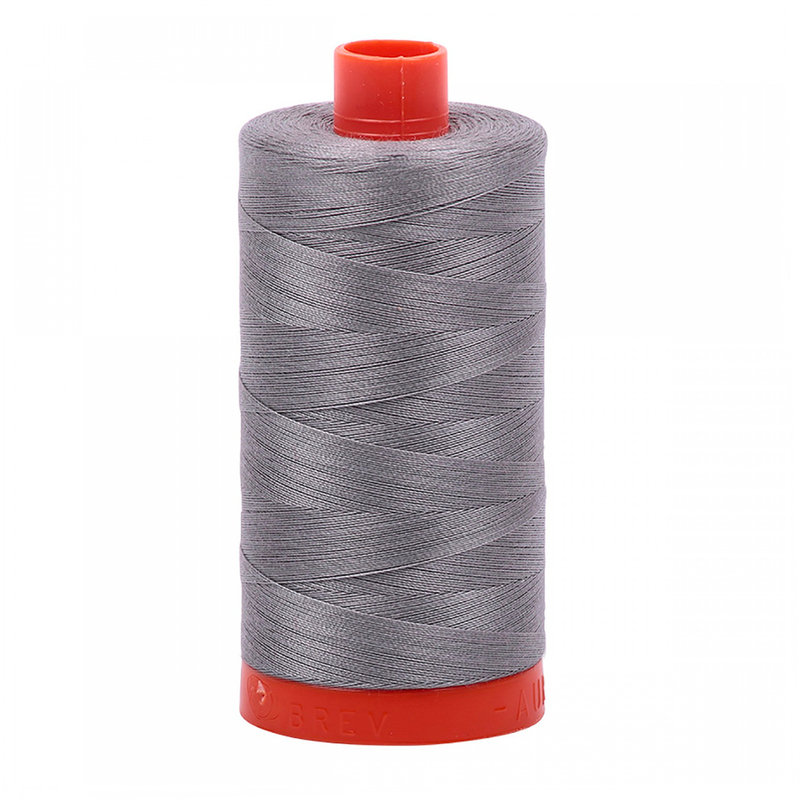 A spool of Aurifil 2625 - Arctic Ice thread on a white background