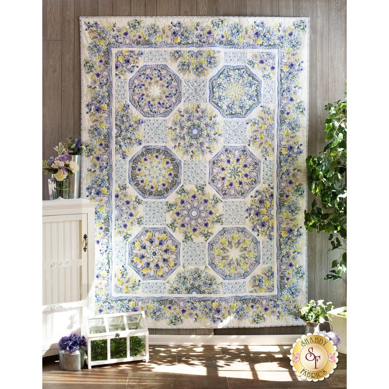 The beautiful Kaleidoscope Quilt made with The Leah Collection fabrics hung on a wall