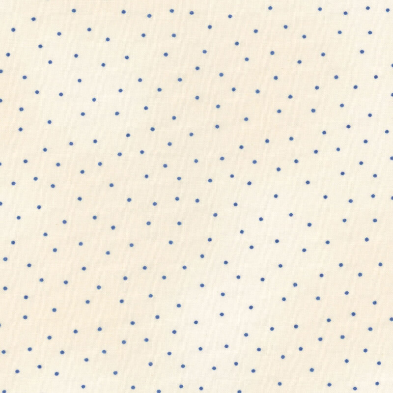Fabric features blue scattered pin dots on mottled dark cream