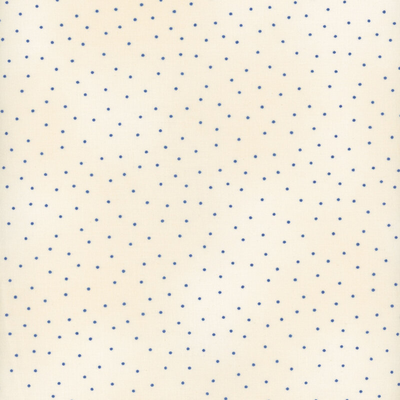 Fabric features blue scattered pin dots on mottled dark cream