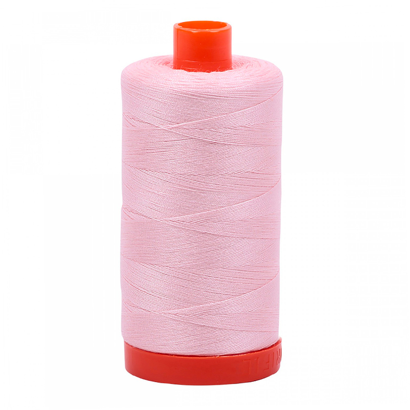 A spool of Aurigil 2410 - Pale Pink thread on a white background