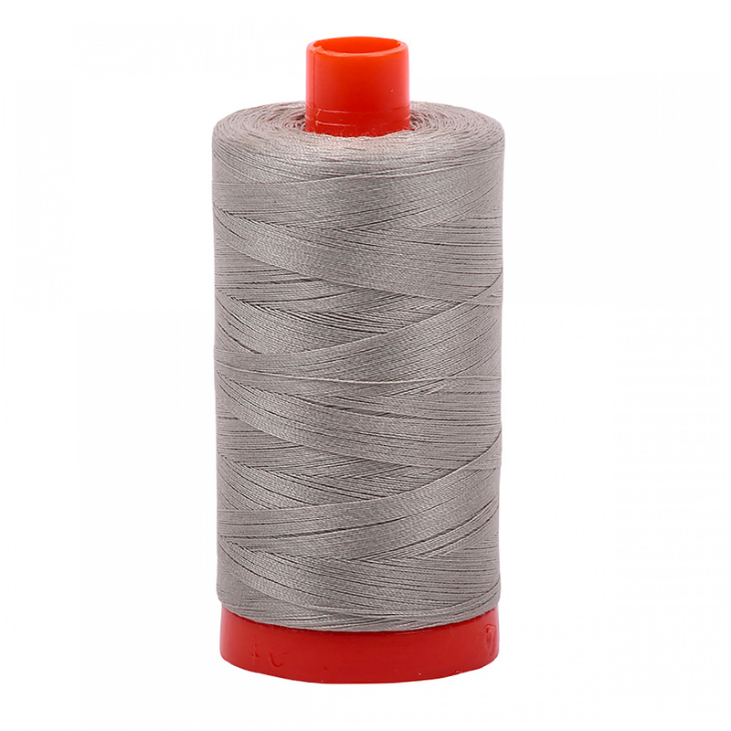 A spool of Aurifil 5021 - Light Grey thread on a white background