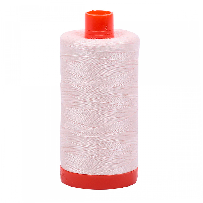 A spool of Aurifil 2405 - Oyster thread on a white background