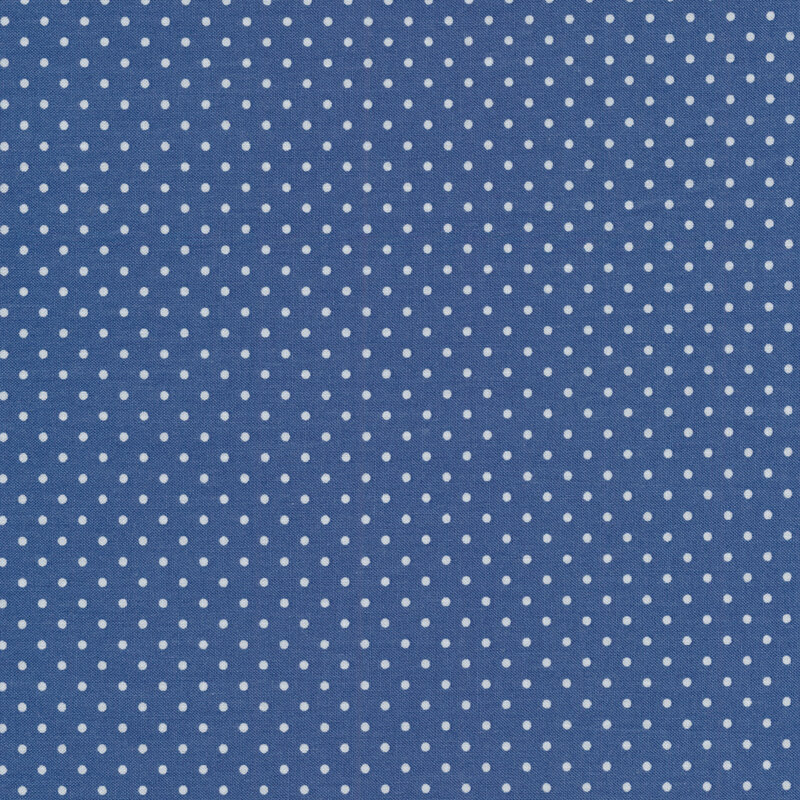 Fabric with small white polka dots all over a deep blue background