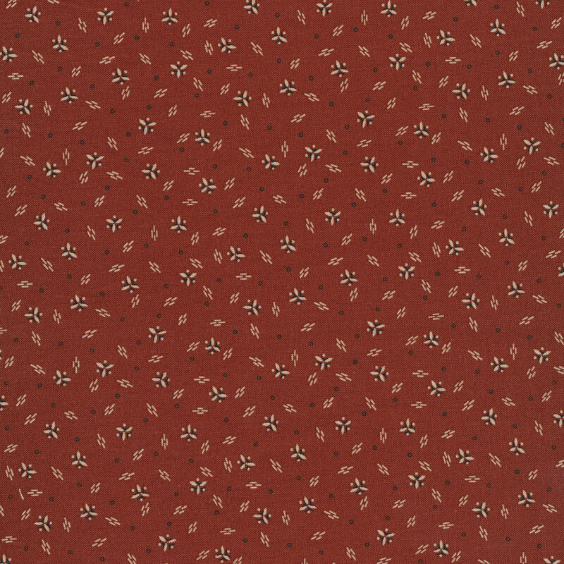 Fabric features cream clustered triangle design with dark accents on red | Shabby Fabrics