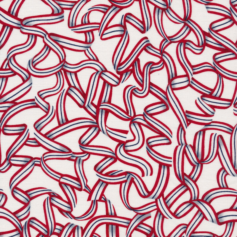 Fabric features red white blue ribbon design strewn on white background | Shabby Fabrics
