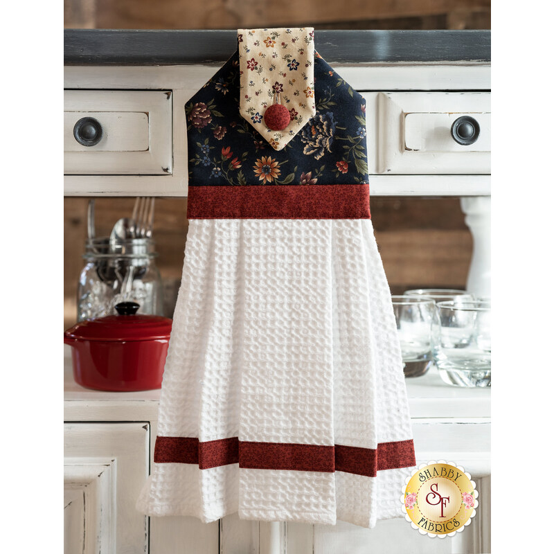 The Through the Years Hanging Towel displayed in front of a cabinet | Shabby Fabrics