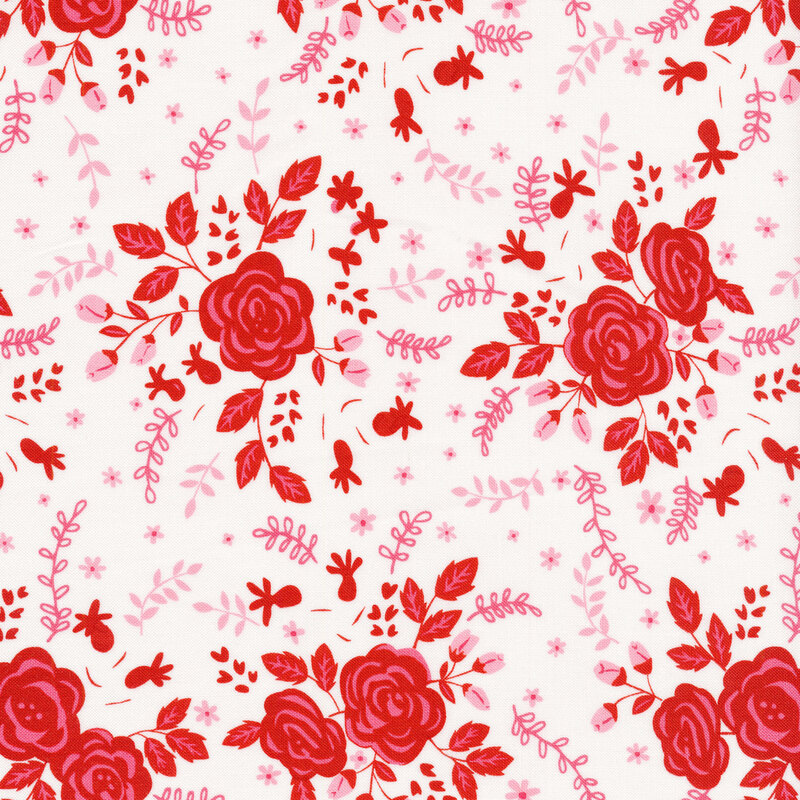 Fabric features pink and red floral design strewn on cream background | Shabby Fabrics