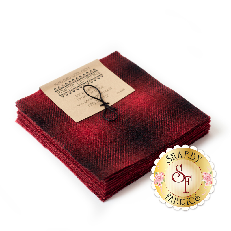 A stack of red and black wool 5" squares in a Primitive Gatherings bundle