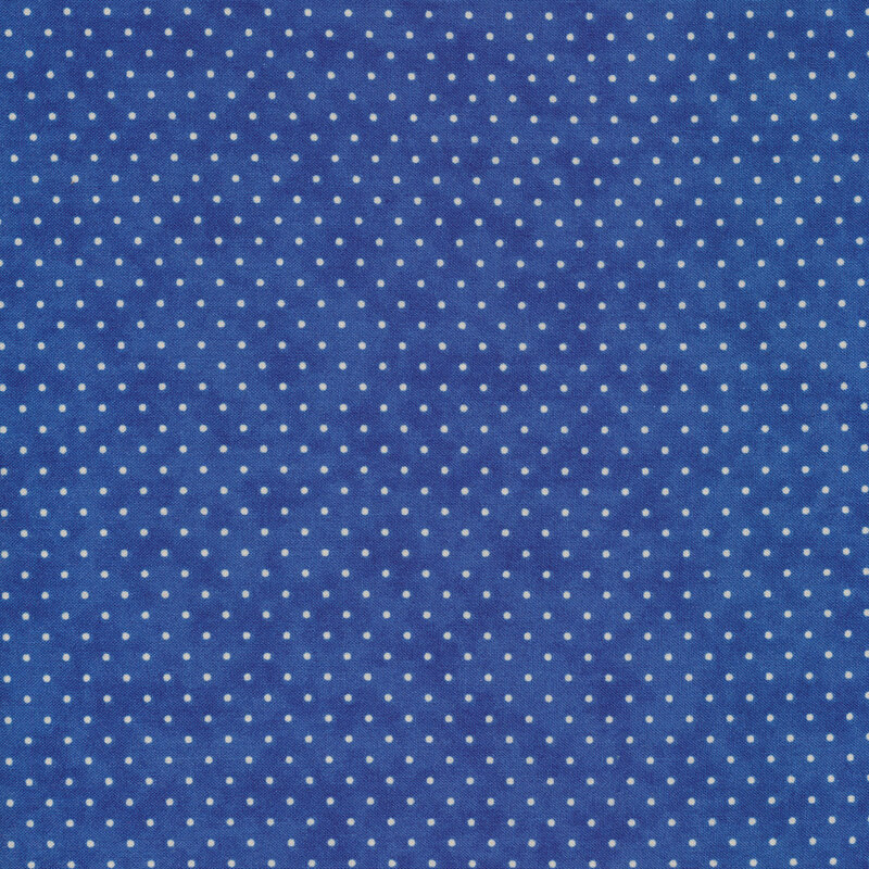 This Moda fabric features a royal blue background with off white polka dots