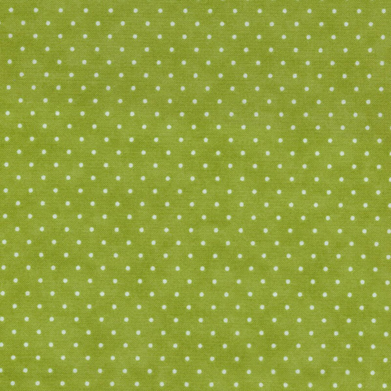This Moda fabric features a light green background with off white polka dots