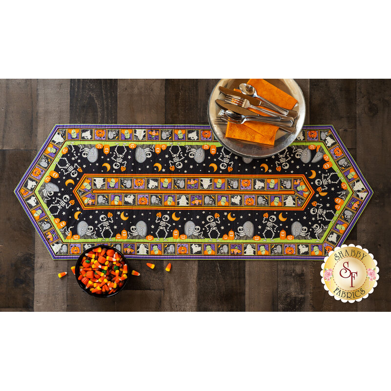 Top down view of the adorable Halloween themed Easy Striped Table Runner with a bowl of candy corn
