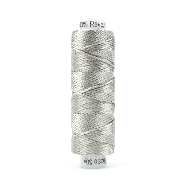 A spool of WonderFil Razzle RZ6103 Paloma Thread on a white background