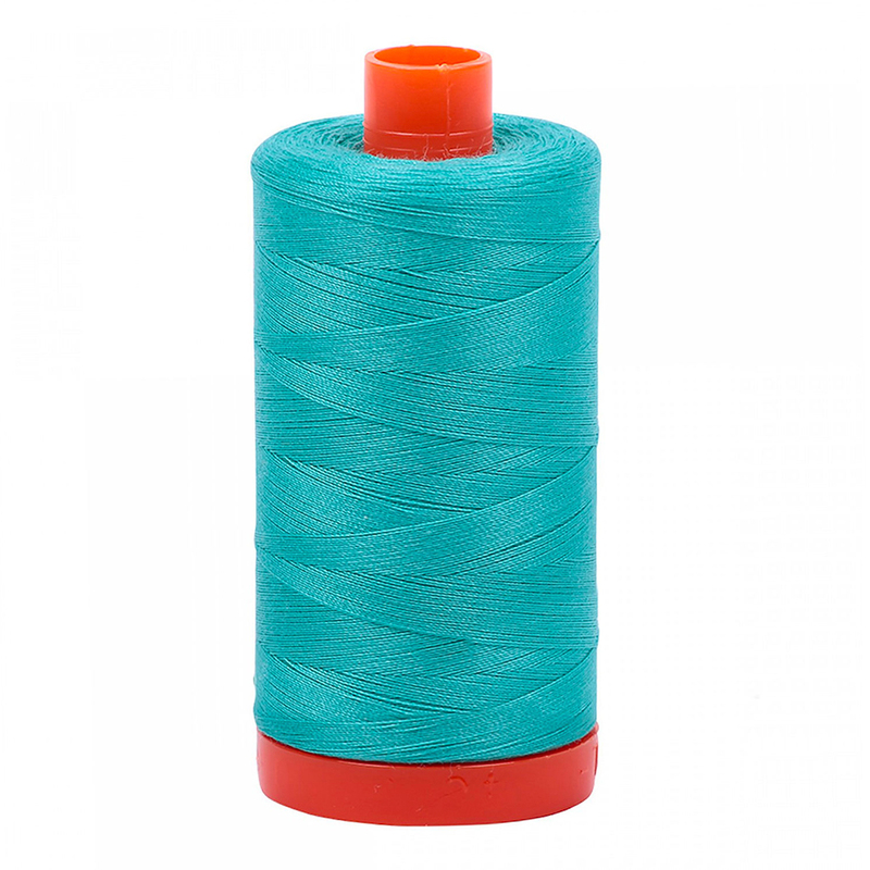 A spool of the Aurifil 1148 - Light Jade thread on a white background