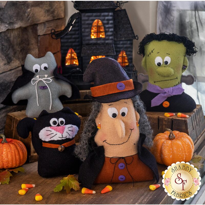 4 Wool felt characters - A black cat, Frakenstein, a witch, and vampire in front of a haunted house