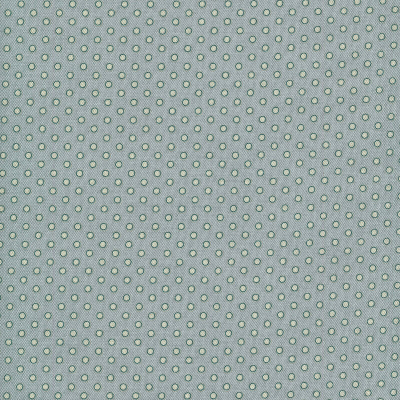 Small tonal polka dots on a dusty blue background